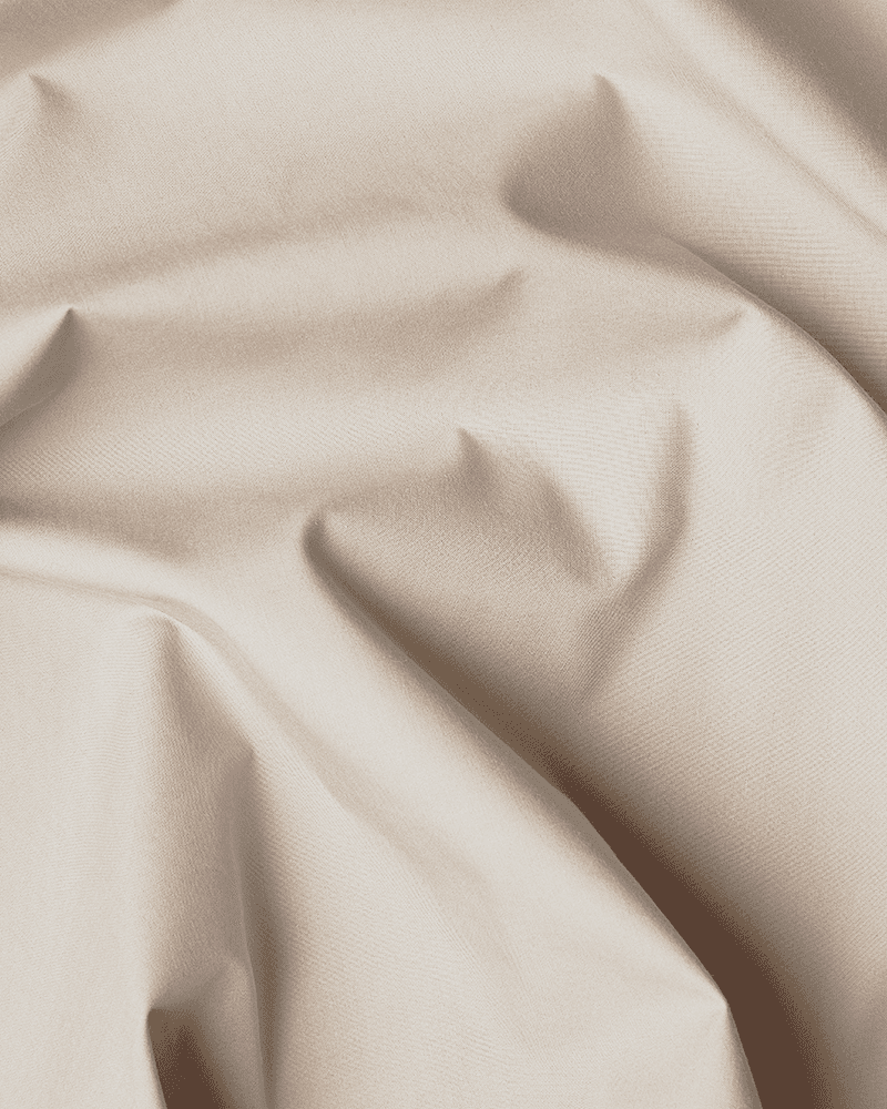 Nærbilde av den beige, OEKO-TEX® STANDARD 100-sertifiserte bomullen som brukes til sengekappen